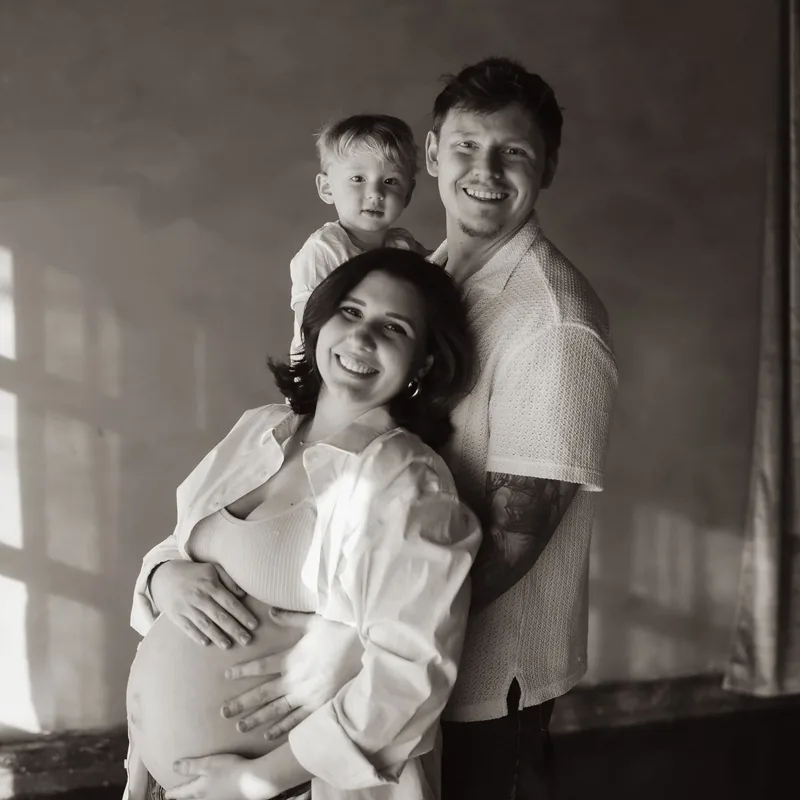 Chase Davis with his wife Amanda and their son, in black and white.